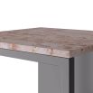 Marble top side table with iron base forming solid panel on one side and open framework on the other 