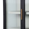A decadent display cabinet with fluted glass doors and brass handles