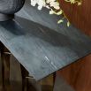 Console table with black marble top and sculptural gold base