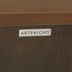 Sleek cabinet with two doors in dark antique brass finish