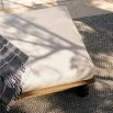 Shop the Caldwell Outdoor Ottoman in stylish Porpoise Boucle. Perfect for lounging, it adds comfort and elegance to your outdoor space.