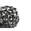 Spiked sculpture in silver with holes throughout