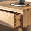 Stylish wooden bedside table with exposed corners