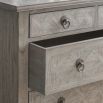 Light wooden five drawer chest of drawers