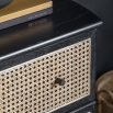 Black framed three drawer chest table with natural rattan fronted drawers