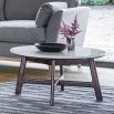 Round coffee table in walnut stained wood with marble top