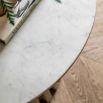 Marble top coffee table with gentle sloping slats for base