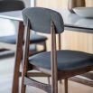 Retro inspired dining chair with grey fabric and walnut stained wooden frame