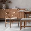 Wishbone back dining chairs with deeply curved back and distinctive hand woven seat