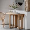 Folding circular wooden dining table with shaped underframe