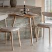 Triangular wooden dining table with three legs