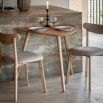 Triangular wooden dining table with three legs