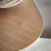 Triangular wooden dining table with three legs