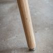 Triangular wooden dining table with three legs