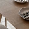 Triangular wooden dining table with three legs