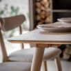 Triangular wooden dining table with three legs