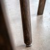 Round wooden dining table with four legs