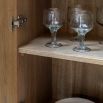 Beautiful cocktail cabinet in oak veneer with a weathered grey finish, paired with black metal legs