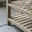 Wooden kitchen island with inset marble slabs on the top, three drawers and two large shelves