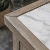 Wooden kitchen island with inset marble slabs on the top, three drawers and two large shelves