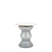 Glass-based side table with sculptural silhouette and round marble top