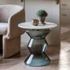 Glass-based side table with sculptural silhouette and round marble top