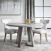 A stylish round and richly grained oak veneer dining table by Uttermost with an elm wood trestle base