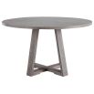 A stylish round and richly grained oak veneer dining table by Uttermost with an elm wood trestle base