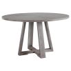 A stylish round and richly grained oak veneer dining table by Uttermost with an elm wood trestle base