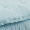 A luxurious pastel blue linen quilt