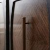 Dark wood sideboard with four panelled doors and brass handles