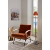 Orange velvet chair with black metal legs and wooden arms
