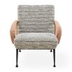 The Gainsbourg Lounge Chair is a vintage-inspired piece with a cushy seat, cerused ash wood arms, and blackened metal legs, perfect for pairing with a sofa.