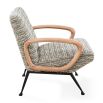 The Gainsbourg Lounge Chair is a vintage-inspired piece with a cushy seat, cerused ash wood arms, and blackened metal legs, perfect for pairing with a sofa.