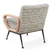 The Gainsbourg Lounge Chair is a vintage-inspired piece with a cushy seat, cerused ash wood arms, and blackened metal legs, perfect for pairing with a sofa.