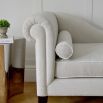 Curvaceous chaise longue with contrasting piping on tapered legs