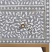 A gorgeous bone inlay chest of drawers with a stainless steel base 