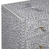A gorgeous bone inlay chest of drawers with a stainless steel base 