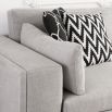 Luxury sofa with deep seat cushions, wide low arms, and nickel studded base