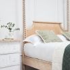 A luxurious acacia and cane 4 poster bed with a rattan headboard