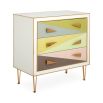 A modern Italian-inspired chest of drawers with angular hardware and brass accents