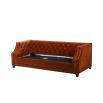 burnt orange sofa bed with deep buttoning and bronze studding 