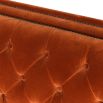 burnt orange sofa bed with deep buttoning and bronze studding 