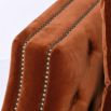 burnt orange sofa bed with deep buttoning and bronze studding 