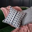 A gorgeous dark blue and white cushion with a lattice inspired design