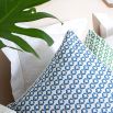 A sumptuous sky blue coloured cushion with a geometric design 