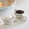 a pair of stylish matte porcelain and gold salt and pepper cellars