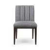 A stylish, contemporary dining chair with a fluted, upholstered back