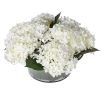 White hydrangea arrangement in leafy glass bowl