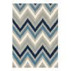 Hand-tufted wool rug with chevron pattern in indigo